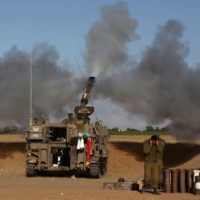 A 155mm artillery, positioned near the Israeli border with the Gaza Strip, fires a projectile towards targets in the Palestinian enclave, on July 17, 2014. Israel and the Islamist Hamas movement have agreed on a ceasefire that will begin at 0300 GMT on Friday, an Israeli official told AFP. AFP PHOTO /MENAHEM KAHANA (Photo credit should read MENAHEM KAHANA/AFP/Getty Images)