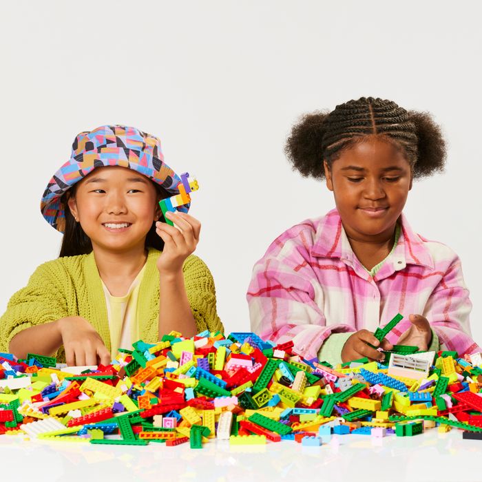 Three children playing with LEGO® bricks