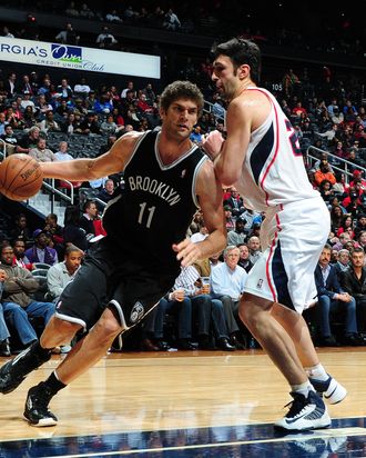 Brook Lopez #11 of the Brooklyn Nets drives to the basket against Zaza Pachulia #27 of the Atlanta Hawks on January 16, 2013 at Philips Arena in Atlanta, Georgia. 