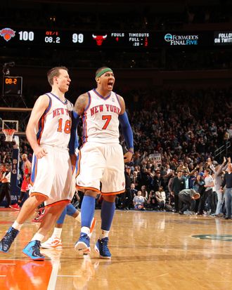 Carmelo Anthony #7 of the New York Knicks, who has hit two last second shots to win in overtime, celebrates victory with Steve Novak #16 of the New York Knicks during the game between the Chicago Bulls and the New York Knicks on April 8, 2012 at Madison Square Garden in New York City, New York.