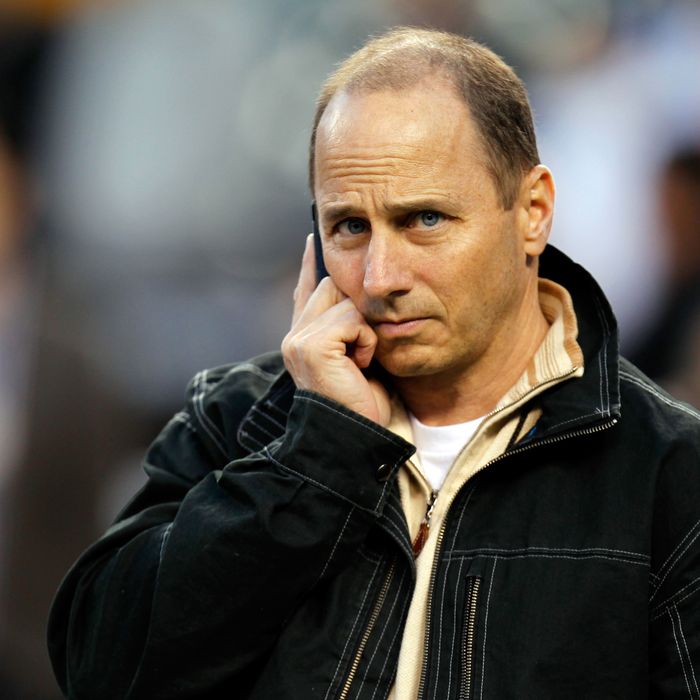 DETROIT, MI - OCTOBER 17: New York Yankees general manager Brian Cashman talks on the phone on the field during batting practice against the Detroit Tigers during game four of the American League Championship Series at Comerica Park on October 17, 2012 in Detroit, Michigan. (Photo by Gregory Shamus/Getty Images)