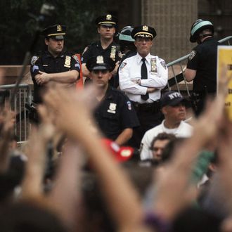 NEW YORK, NY - SEPTEMBER 30: Demonstrators rally outside One Police Plaza as police look on during a march by protestors affiliated with the Occupy Wall Street movement on September 30, 2011 New York City. Over one thousand activists marched to protest police brutality while clogging traffic in Lower Manhattan. Occupy Wall Street demonstrators are opposed to outsized corporate profits on Wall Street. (Photo by Mario Tama/Getty Images)