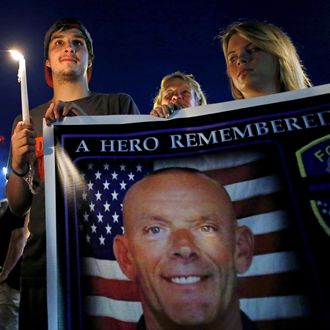 Mourners attend a candlelight vigil for slain Fox Lake Police Lieutenant Charles Joseph Gliniewicz in Fox Lake