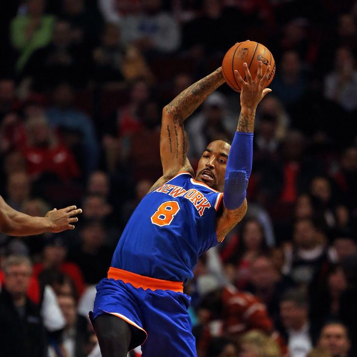 J.R. Smith #8 of the New York Knicks rebounds against the Chicago Bulls at the United Center on April 11, 2013 in Chicago, Illinois. 