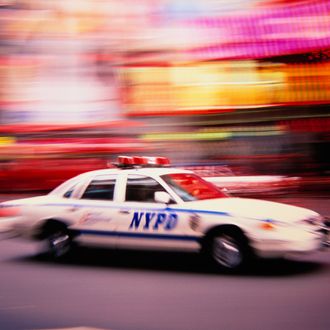 Police Car Speeding on Street.