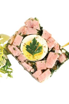 Ham terrine en gelee with parsley and egg.