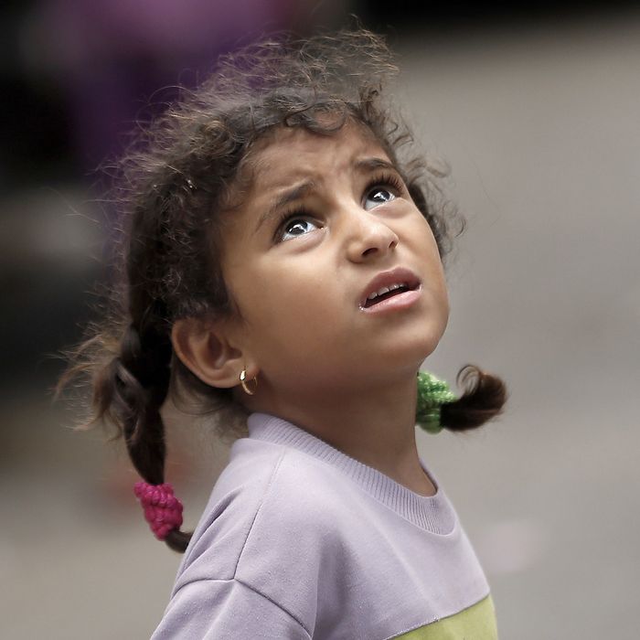 A Palestinian girl looks up as she watches an Israeli drone flying over her home in Gaza City, early on July 15, 2014. Israel's security cabinet accepted an Egyptian ceasefire proposal, a government spokesman said, after a week of the deadliest violence in and around Gaza in years. 