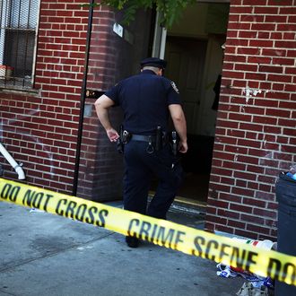 Police stand near the scene of a murder in the Brooklyn borough of New York City. 