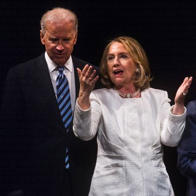 Former US Secretary of State Hillary Clinton and Vice President Joe Biden speak at the end of the Vital Voices Global Awards ceremony at the Kennedy Center in Washington on April 2, 2013. The event honors 