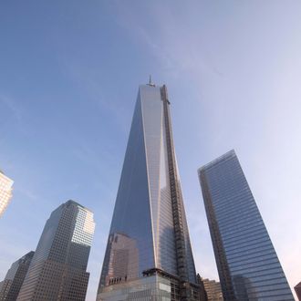 One World Trade Center looms over the north reflecting pool at the 9/11 Memorial during ceremonies for the 12th anniversary of the terrorist attacks on lower Manhattan at the World Trade Center site on September 11, 2013 in New York City. 