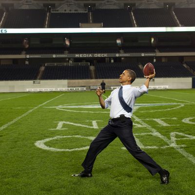President Barack Obama throws a football on the field at Soldier Field following the NATO working dinner in Chicago, Illinois, May 20, 2012. 