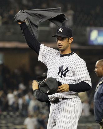 Jorge Posada #20 of the New York Yankees celebrates after clinching the American League East division against the Tampa Bay Rays on September 21, 2011.