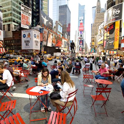 People sit at tables in Times Square in New York, U.S., on T