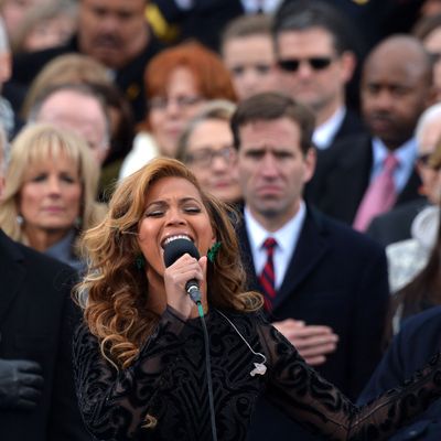 Beyonce performs the National Anthem as Vice-President Joe Biden, his wife Dr. Jill Biden (2nd L), his son Beau Biden (C background), former President Bill Clinton (far L) and wife, US Secretary of State Hillary Clinton (C-background), and US Justice Anthony Kennedy (R) listen during the 57th Presidential Inauguration ceremonial swearing-in at the US Capitol on January 21, 2013 in Washington, DC.