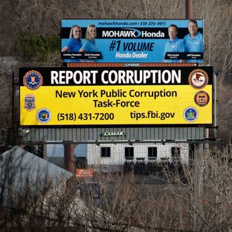 In this Wednesday, Jan. 27, 2016, photo, a billboard with a message about reporting public corruption, left, stands along Interstate 90 in Albany, N.Y. Authorities in New York's corruption-plagued capital city are using billboards to urge citizens to report crooked politicians, using a tactic more commonly employed to find missing people or fight drunk driving. (AP Photo/Mike Groll)