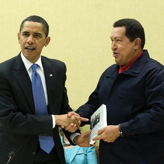 Venezuelan President Hugo Chavez (R) gives a book, 'The Open Viens of Latin America' of Uruguayan writer Eduardo Galeano to US President Barack Obama (L) during a multilateral meeting to begin during the Summit of the Americas at the Hyatt Regency in Port of Spain, Trinidad April 18, 2009. AFP PHOTO/Jim WATSON (Photo credit should read JIM WATSON/AFP/Getty Images)