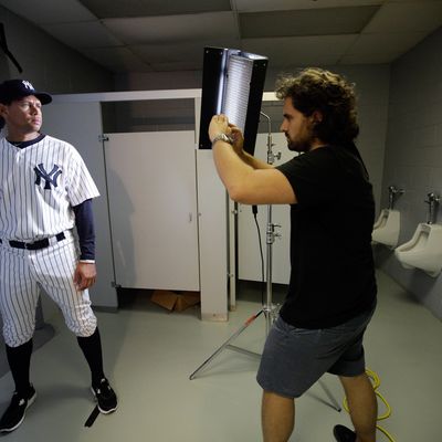 New York Yankees' Alex Rodriguez, left, poses for photographer Nick Laham on photo day during baseball spring training, Monday, Feb. 27, 2012, in Tampa, Fla.