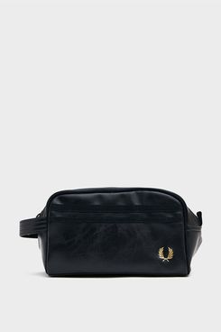 A black leatherFred Perry classic travel wash bag with a black zipper and elastic trim and a gold embroidered logo. The Strategist - 48 Things on Sale You’ll Actually Want to Buy: From Sunday Riley to Patagonia