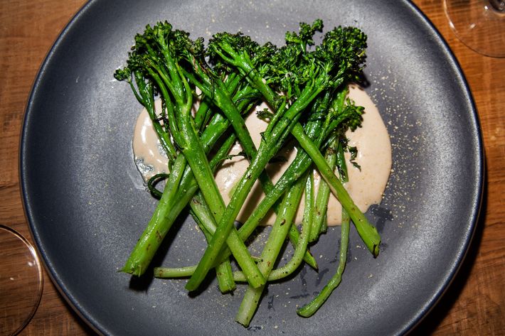 Charred broccolini tonnato gets dusted with nutritional yeast.