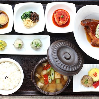 Korean traditional set meal with rice, jjigae (stew), fish, vegetable side dishes