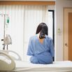 Worried patient women sitting up in the hospital bed with sadness emotion