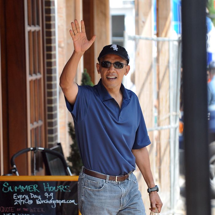 US President Barack Obama waves after shopping at Bunch of Grapes bookstore with his daughters Malia and Sasha in Vineyard Haven on Martha's Vineyard, Massachusetts, on August 20, 2010. The First Family is on vacation on the Island. AFP PHOTO/Jewel Samad (Photo credit should read JEWEL SAMAD/AFP/Getty Images)