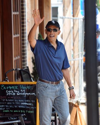 US President Barack Obama waves after shopping at Bunch of Grapes bookstore with his daughters Malia and Sasha in Vineyard Haven on Martha's Vineyard, Massachusetts, on August 20, 2010. The First Family is on vacation on the Island. AFP PHOTO/Jewel Samad (Photo credit should read JEWEL SAMAD/AFP/Getty Images)