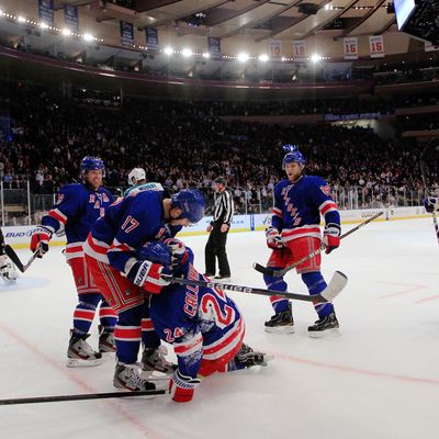 NEW YORK - OCTOBER 31: Ryan Callahan #24 of the New York Rangers is helped up by teammate Brandon Dubinsky #17 after falling on his back after scoring a goal in the second period against the San Jose Sharks at Madison Square Garden on October 31, 2011 in New York City. (Photo by Chris Trotman/Getty Images)