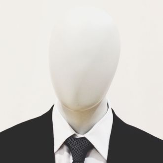Close-Up Of Mannequin Dressed In Suit Against White Background