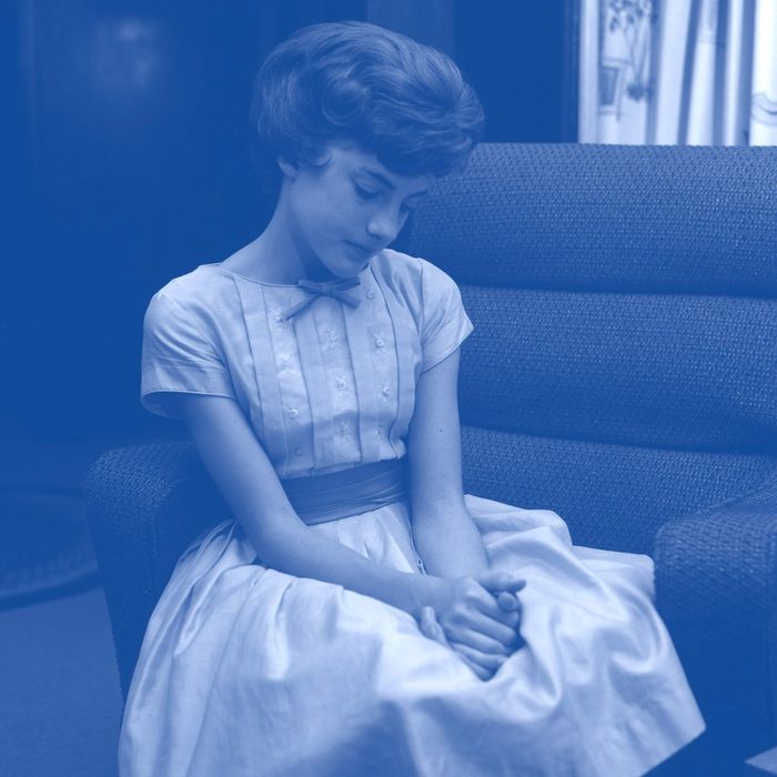 Young woman sitting on sofa