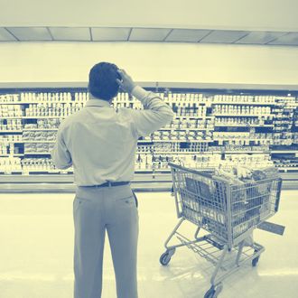 Man Standing in Grocery Store Aisle.