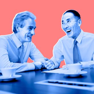 Businessmen laughing in meeting 