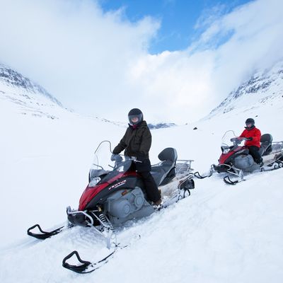 Snowmobiling in the arctic alps in the Arctic Circle near Holt in the region of Tromso, Northern Norway