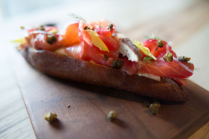 Beet-cured salmon on a pretzel roll with celery cream cheese.