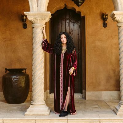 American singer Cher in her home wearing a Moroccan caftan