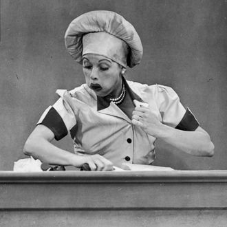 American actresses Vivian Vance (1909 - 1979), as Ethel Mertz, and Lucille Ball (1911 - 1989), as Lucy Ricardo, work side-by side at a candy factory conveyor belt in an episode of the television comedy 'I Love Lucy' entitled 'Job Switching,' Los Angeles, California, May 30, 1952. 