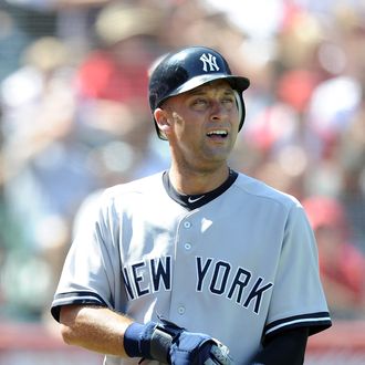 Derek Jeter #2 of the New York Yankees heads to the dugout after scoring a run against the Los Angeles Angels of Anaheim at Angel Stadium of Anaheim on September 11, 2011 in Anaheim, California.