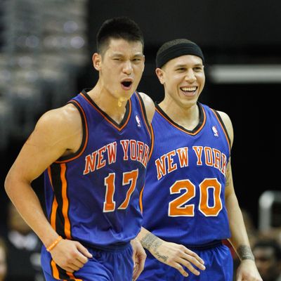 Jeremy Lin #17 of the New York Knicks and Mike Bibby #20 celebrate after Lin scored against the Washington Wizards during the second half at Verizon Center on February 8, 2012 in Washington, DC.