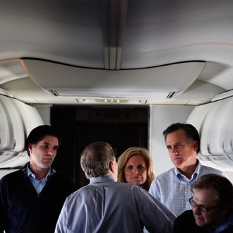 IN FLIGHT - JANUARY 04: Republican presidential candidate and former Massachusetts Governor Mitt Romney (2nd R) talks with (L-R) son Tagg Romney, campaign advisors Stuart Stevens, wife Ann Romney and advisor Eric Fehrnstrom on a chartered airplane after departing Des Moines, Iowa, January 4, 2012 while en route to Manchester, New Hampshire. Romney beat former U.S. Senator Rick Santorum by only eight votes in Tuesday's 