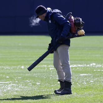 A member of the grounds crew blows ice chunks off the field before a baseball game between the Houston Astros and the New York Yankees at Yankee Stadium, Tuesday, April 5, 2016 in New York. The opener between the Astros and Yankees was postponed Monday because of rain and cold. (AP Photo/Seth Wenig)