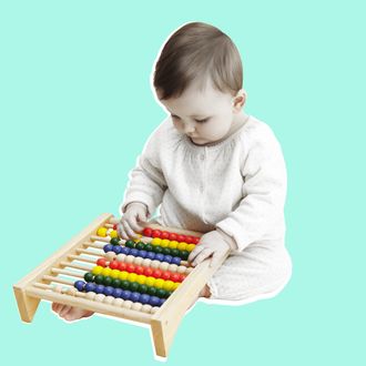 Studio portrait of baby girl playing with abacus