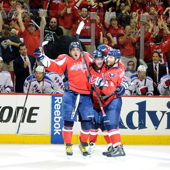 WASHINGTON, DC - MAY 05: Mike Green #52 of the Washington Capitals celebrates with Alex Ovechkin #8 and Dennis Wideman #6 after scoring the game winning goal in the third period against the New York Rangers in Game Four of the Eastern Conference Semifinals during the 2012 NHL Stanley Cup Playoffs at the Verizon Center on May 5, 2012 in Washington City. Washington won the game 3-2. (Photo by Greg Fiume/Getty Images)
