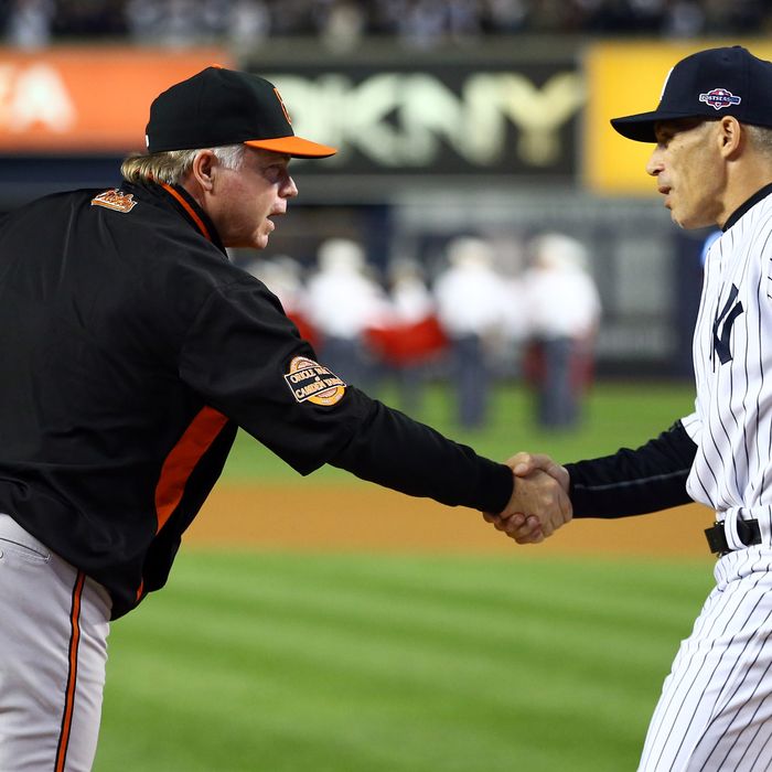 Buck Showalter of the Baltimore Orioles greets Joe Girardi of the New York Yankees prior to Game Three of the American League Division Series at Yankee Stadium on October 10, 2012 in the Bronx borough of New York City.