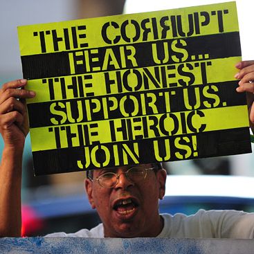 Protesters shout slogans while holding banners after marching to the courthouse where the trial for Michael Jackson's doctor continues on October 3, 2011 in Los Angeles. They say they are inspired by revolutions in the Middle East, but protests over economic grievances in Spain and elsewhere in Europe are a closer comparison as anti-corporate demonstrations spread across the United States. As the Occupy Wall Street protest entered its third week Monday, it is being taken more seriously with similar sit-in demonstrations popping up from Boston to Chicago and Los Angeles and this week the New York protest expects to swell with support from trade unions. AFP PHOTO/Frederic J. BROWN (Photo credit should read FREDERIC J. BROWN/AFP/Getty Images)