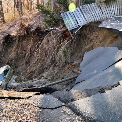 A vehicle sitting at the bottom of a large sinkhole is shown in this handout photo provided by the south Amboy Police Department in Amnboy, New Jersey March 24, 2015. The large sinkhole, believed to have been caused by an underground water main break, forced the evacuations of four New Jersey homes about 20 miles south of Newark, after suddenly forming early on Tuesday, crumbling part of a roadway and swallowing a car, police said. REUTERS/Amboy Police Dept/Handout via Reuters ATTENTION EDITORS - FOR EDITORIAL USE ONLY. NOT FOR SALE FOR MARKETING OR ADVERTISING CAMPAIGNS. THIS PICTURE WAS PROVIDED BY A THIRD PARTY. REUTERS IS UNABLE TO INDEPENDENTLY VERIFY THE AUTHENTICITY, CONTENT, LOCATION OR DATE OF THIS IMAGE. THIS PICTURE IS DISTRIBUTED EXACTLY AS RECEIVED BY REUTERS, AS A SERVICE TO CLIENTS - RTR4UOGL
