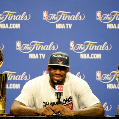 LeBron James #6 of the Miami Heat answers questions from the media next to the Larry O'Brien Finals Championship trophy and James' Bill Russell Finals MVP trophy during his post game press conference after they won 121-106 against the Oklahoma City Thunder in Game Five of the 2012 NBA Finals on June 21, 2012 at American Airlines Arena in Miami, Florida. 