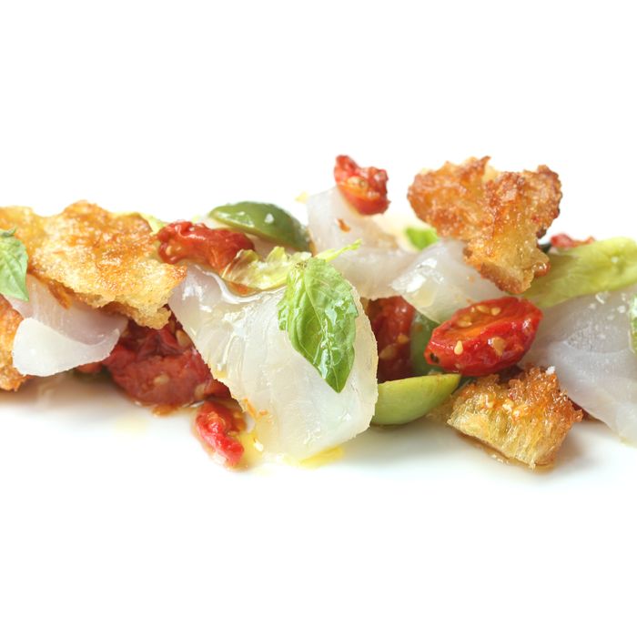 At Costata, fluke crudo comes with tomato confit, olives, and basil.